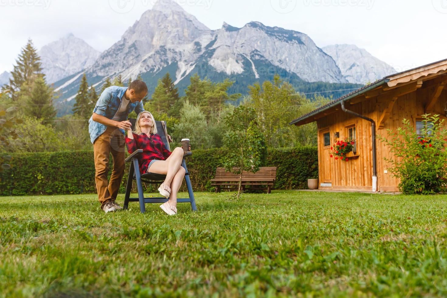 Young lovers relaxing on holiday in beautiful panorama with mountains Bavaria Germany. Couple in love relaxing in spring photo