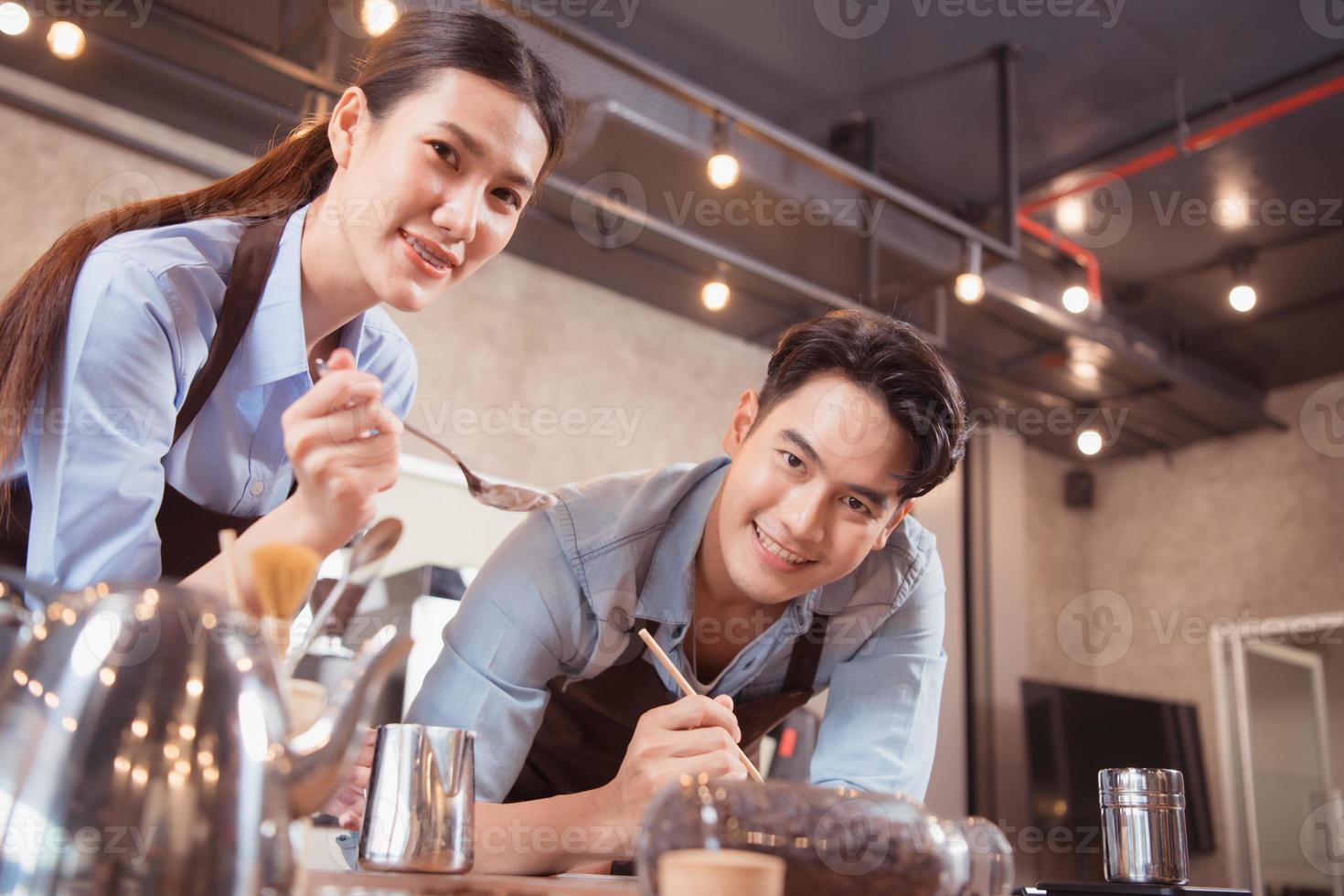 Before competing in the championship level coffee brewing competition, both of the baristas practice their coffee latte makeup techniques to become proficient. photo