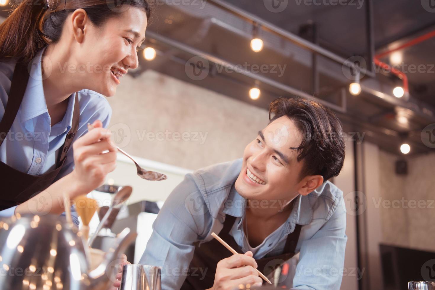 Before competing in the championship level coffee brewing competition, both of the baristas practice their coffee latte makeup techniques to become proficient. photo