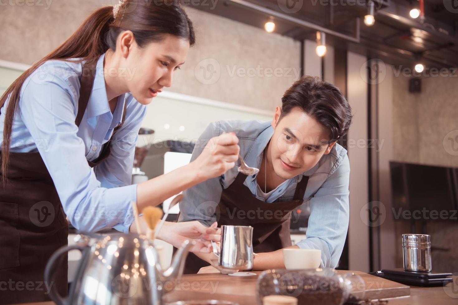 Before competing in the championship level coffee brewing competition, both of the baristas practice their coffee latte makeup techniques to become proficient. photo