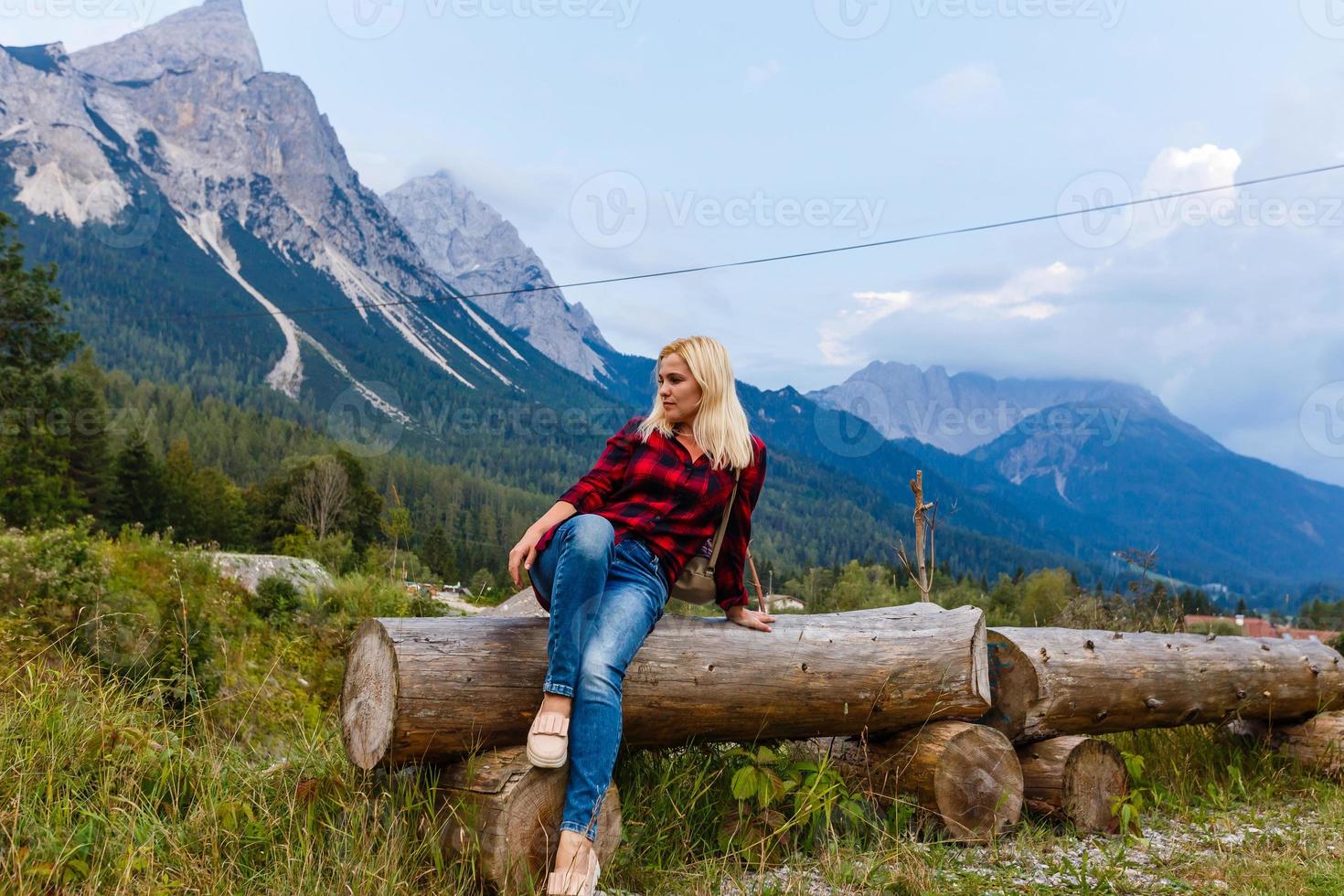 Young beautiful woman traveler , mountains Alps background, photo