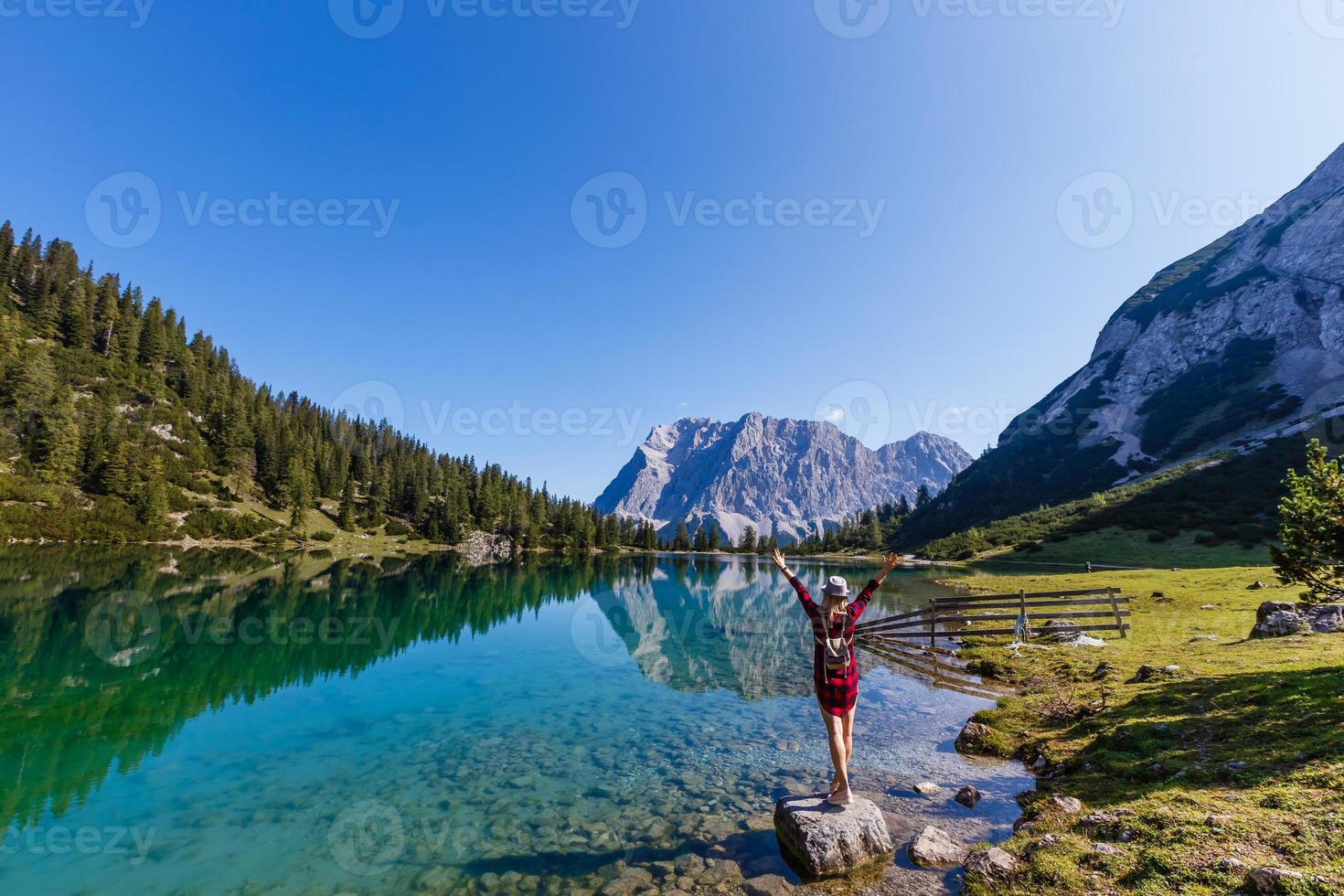 woman enjoying beauty of nature looking at mountain. Adventure travel, Europe. Woman stands on background with Alps. photo