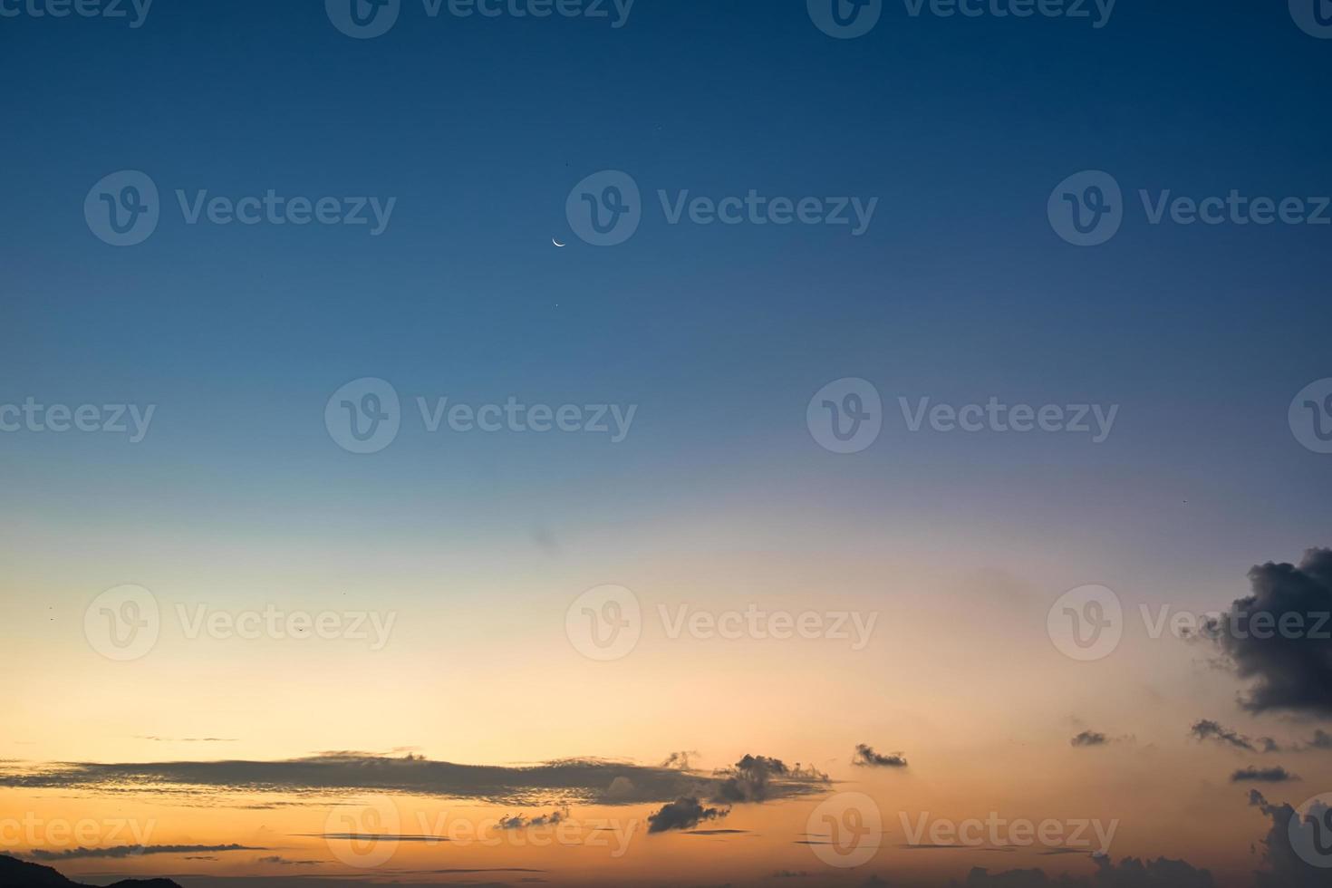 Evening golden hour sky with moon photo