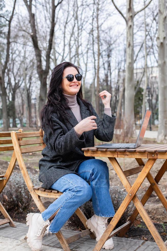 Beautiful businesswoman working on a laptop. Female freelancer connecting to internet via computer. Blogger or journalist writing new article. photo