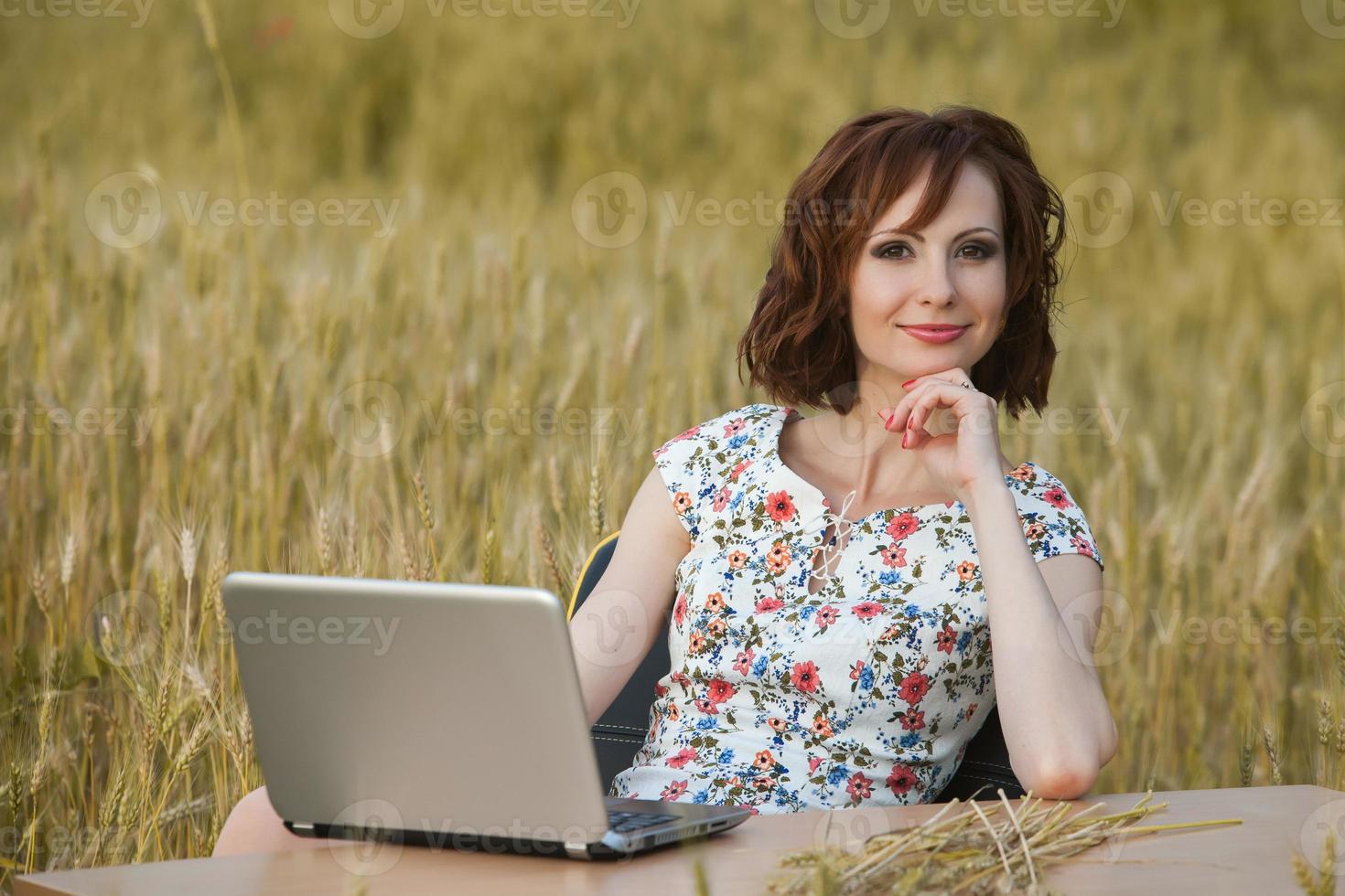 Beautiful woman or business woman talking on a cell phone outside. Outdoor portrait of a beautiful happy businesswoman talking on cell phone. photo