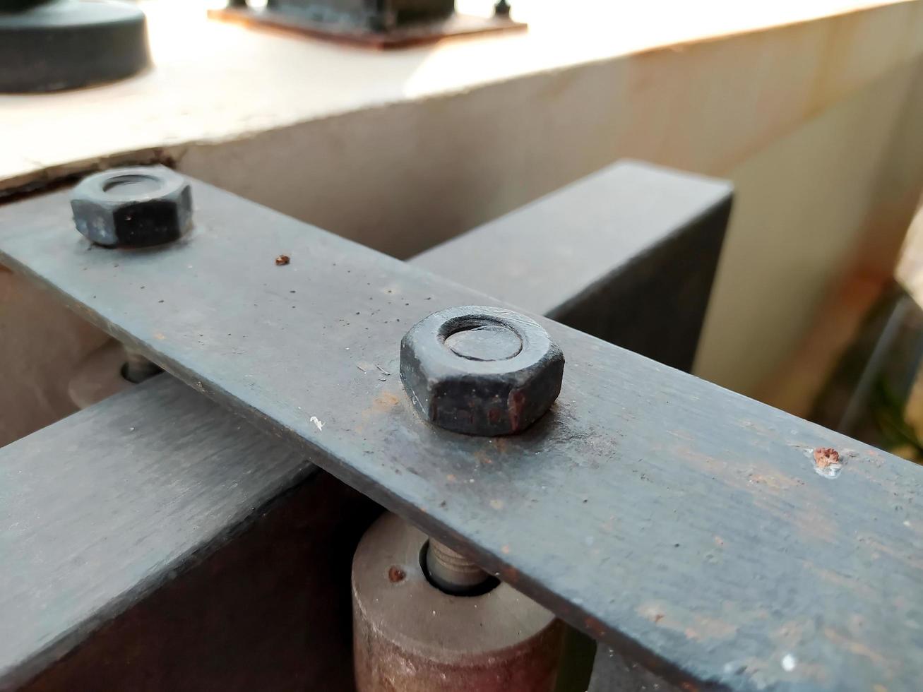 Close-up of a rusty black nut screw. photo