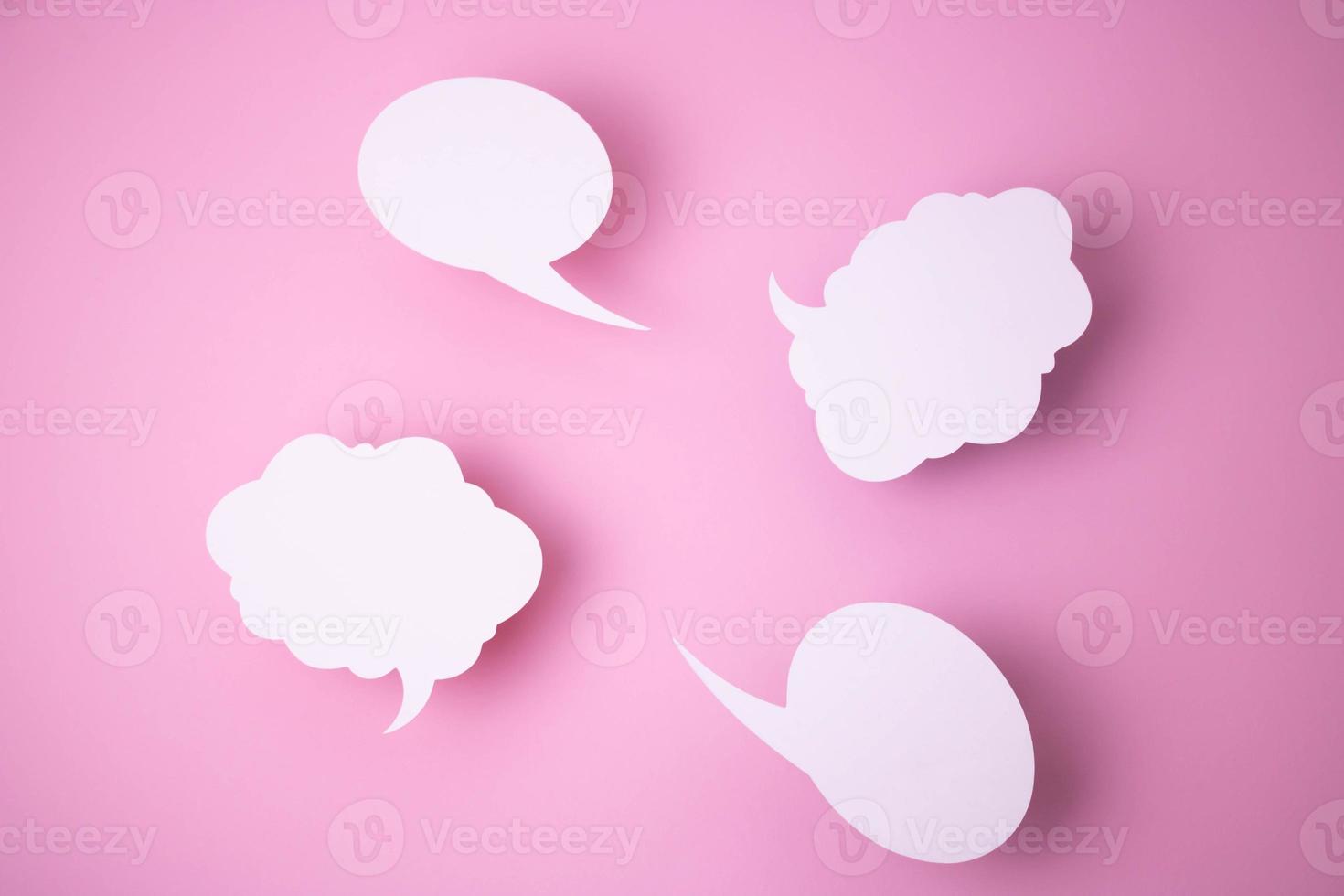 Paper templates in the form of clouds and bubbles for messages on a pink background. photo