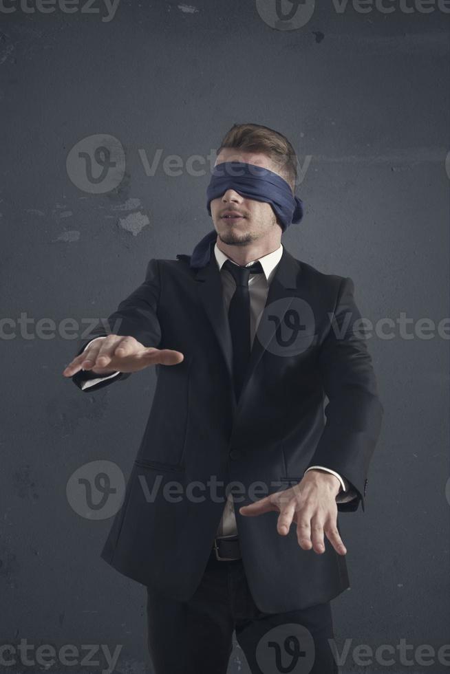 Blind businessman on dark background photo