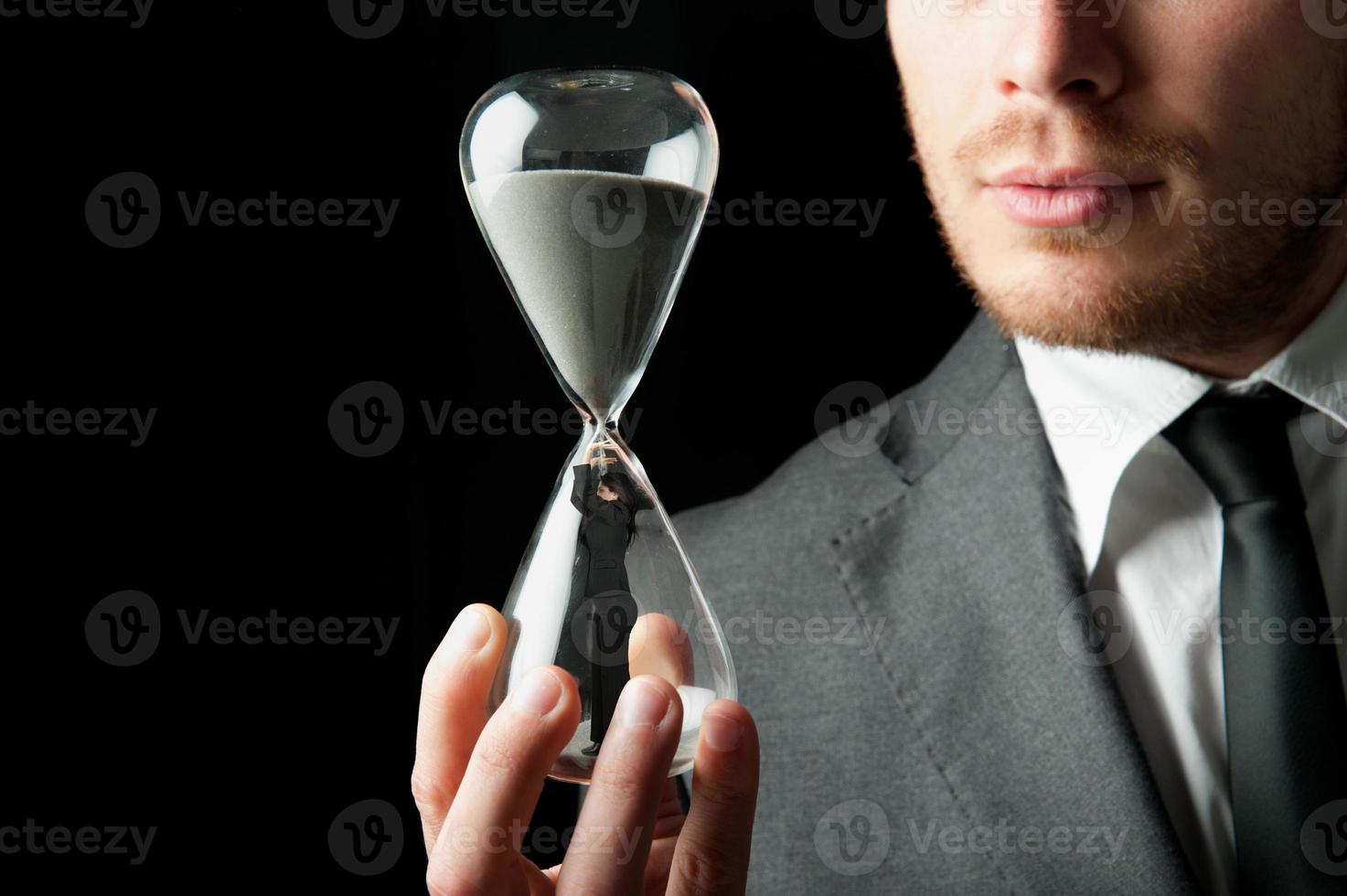 Businessman holding an hourglass photo