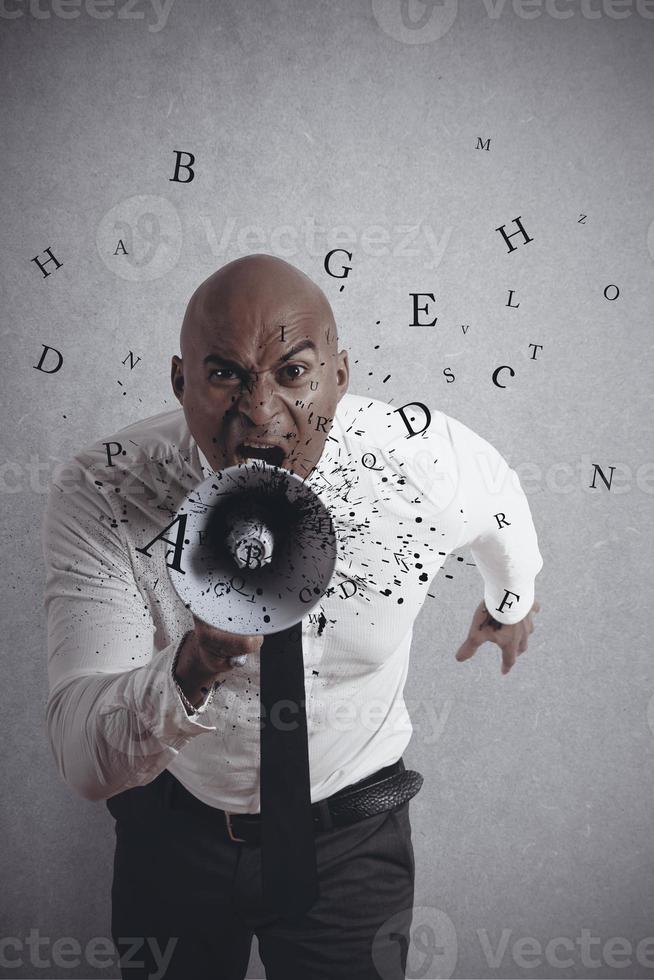 Shouting businessman with loudspeaker photo