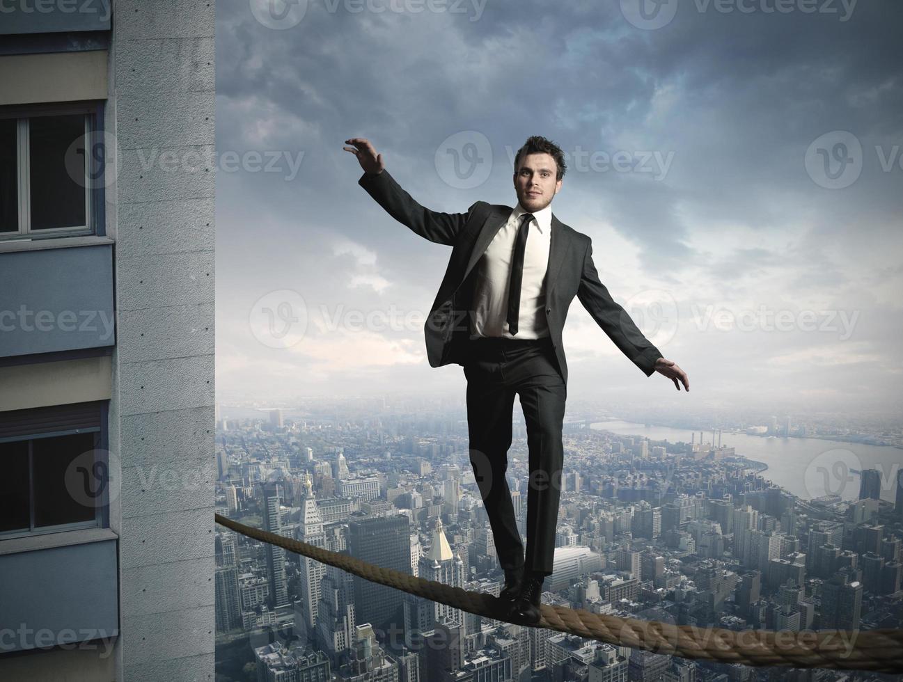 Equilibrist businessman having difficulties photo