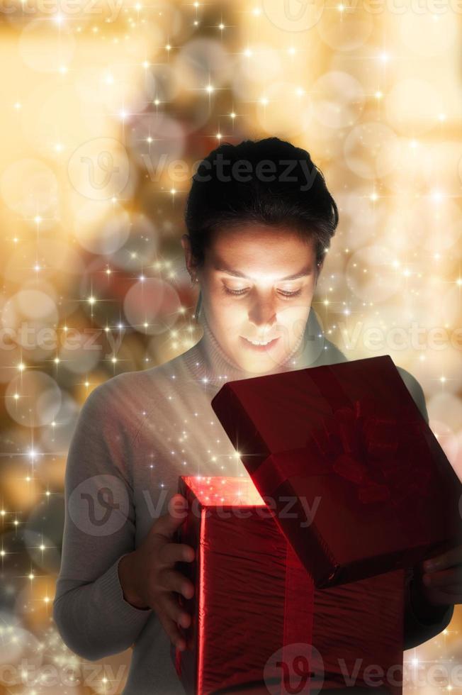 Woman opening Christmas present photo