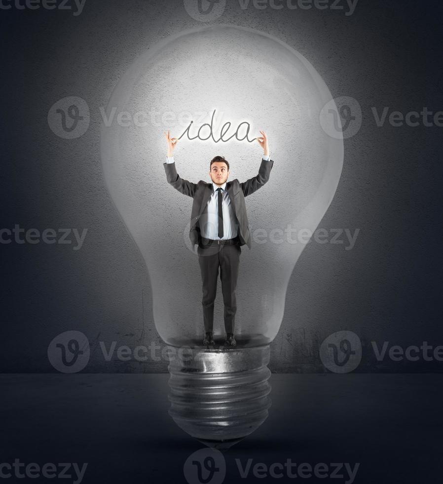 Great idea concept with businessman and light bulb photo