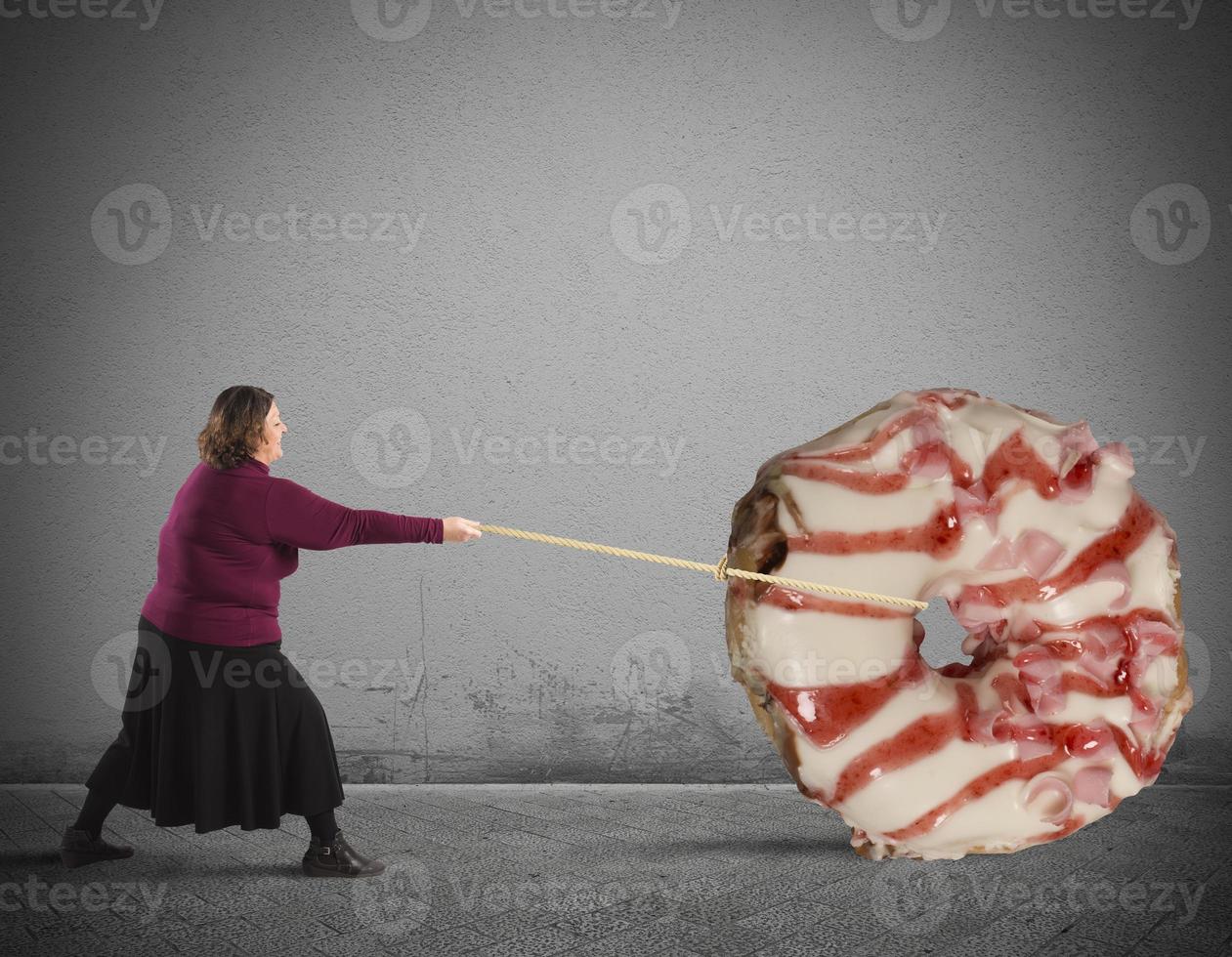 Woman pulling a Giant donut photo