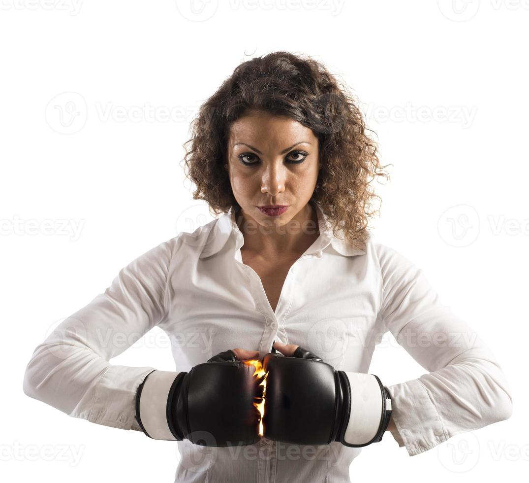 Determined businesswoman with boxing gloves photo