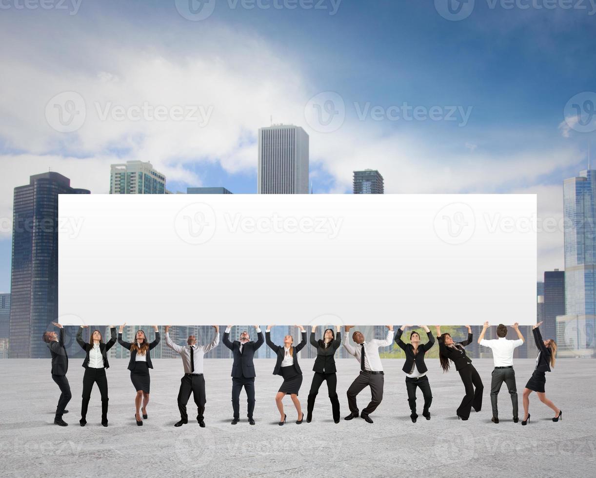 Business team holding a blank banner photo