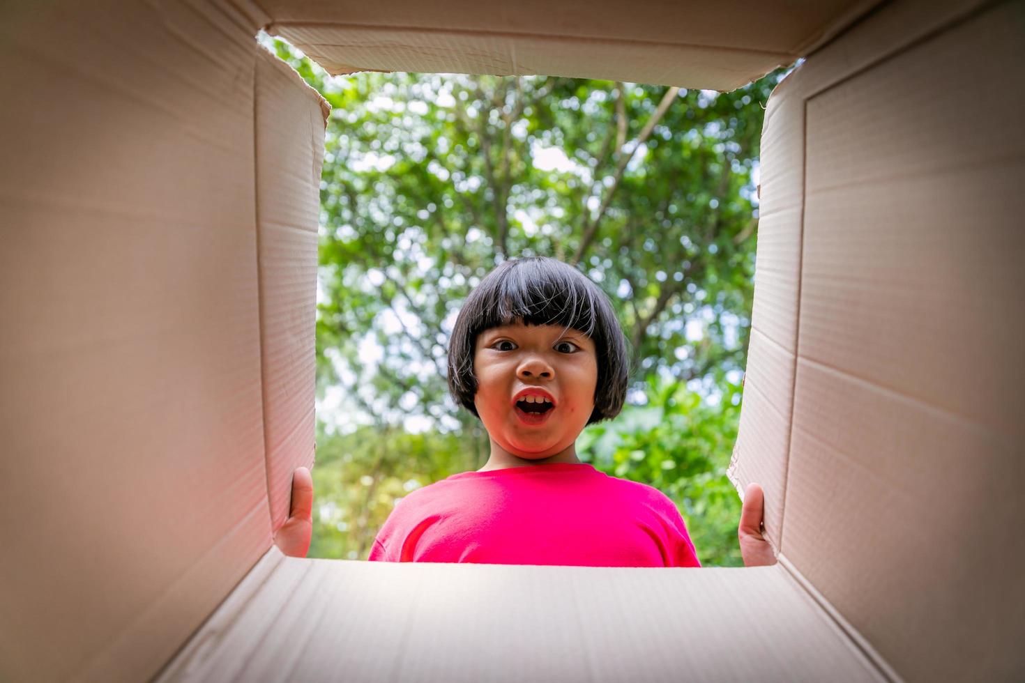 Asian children playing in cardboard boxes photo