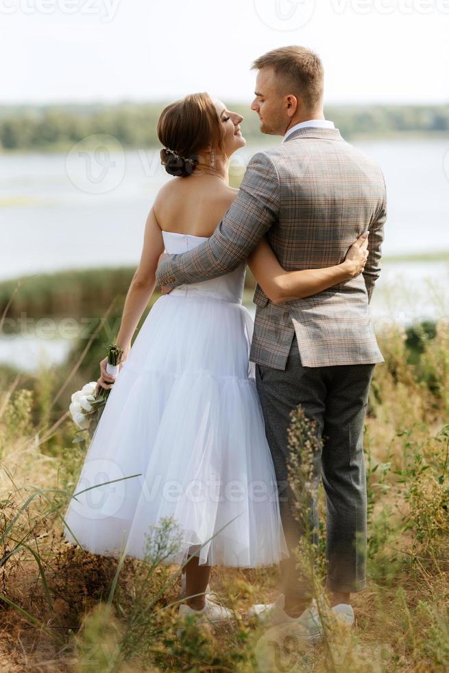 young couple a guy and a girl are walking in the green hills photo