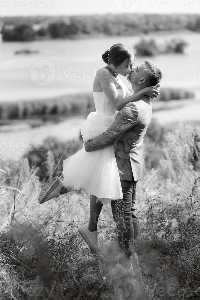 young couple a guy and a girl are walking in the green hills photo