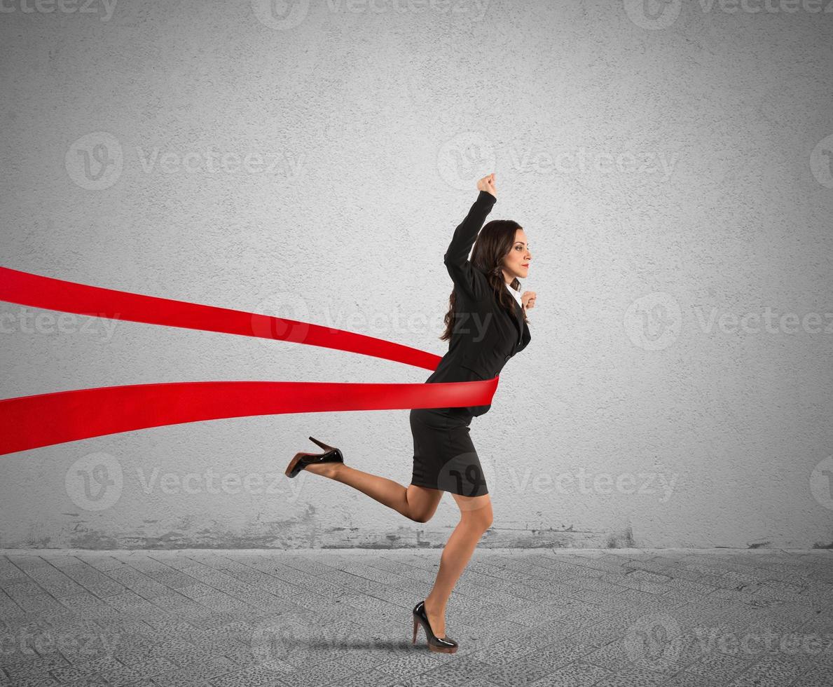 Winner businesswoman reaching the finish line photo