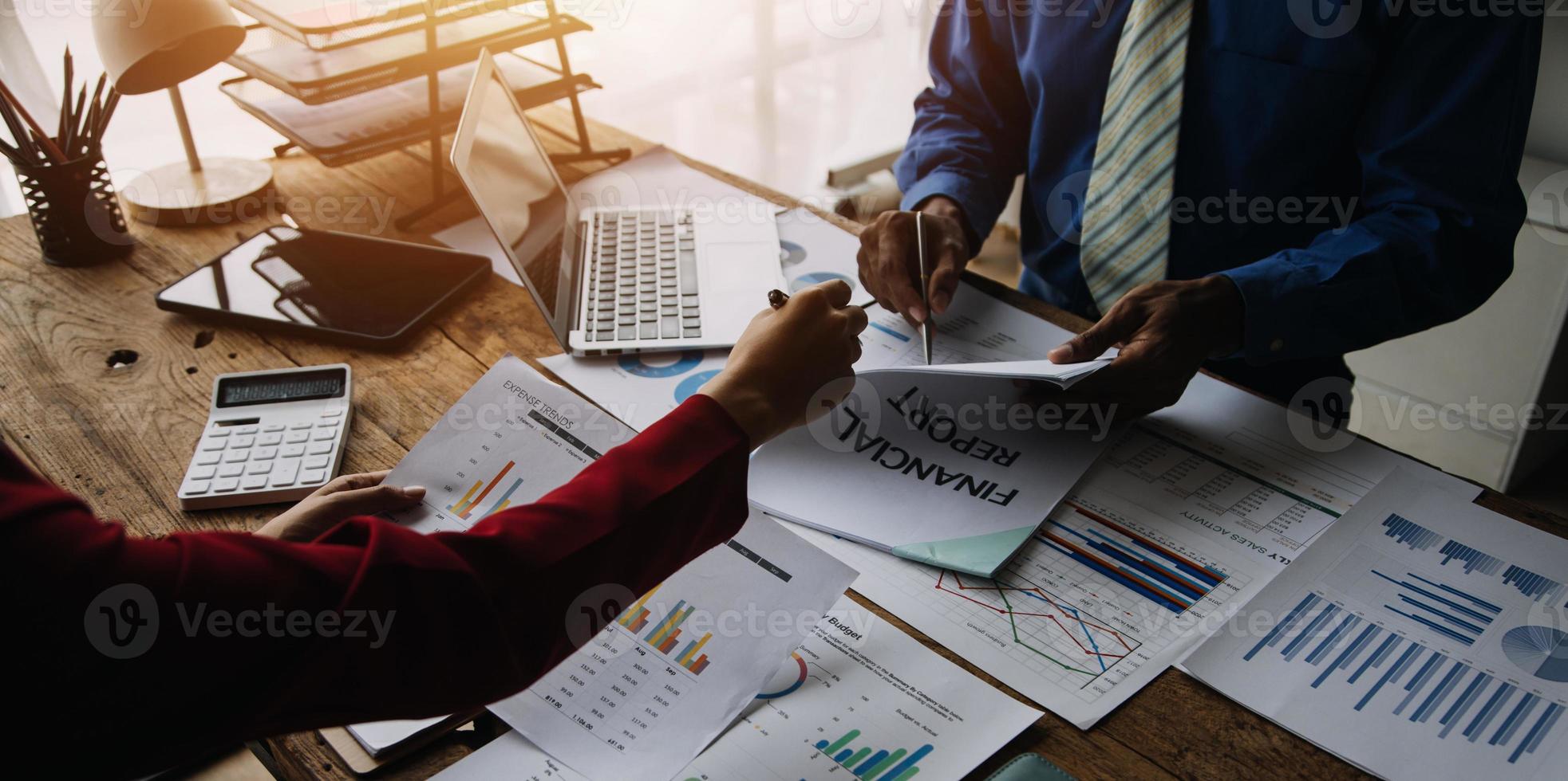 Group of confident business people point to graphs and charts to analyze market data, balance sheet, account, net profit to plan new sales strategies to increase production capacity. photo