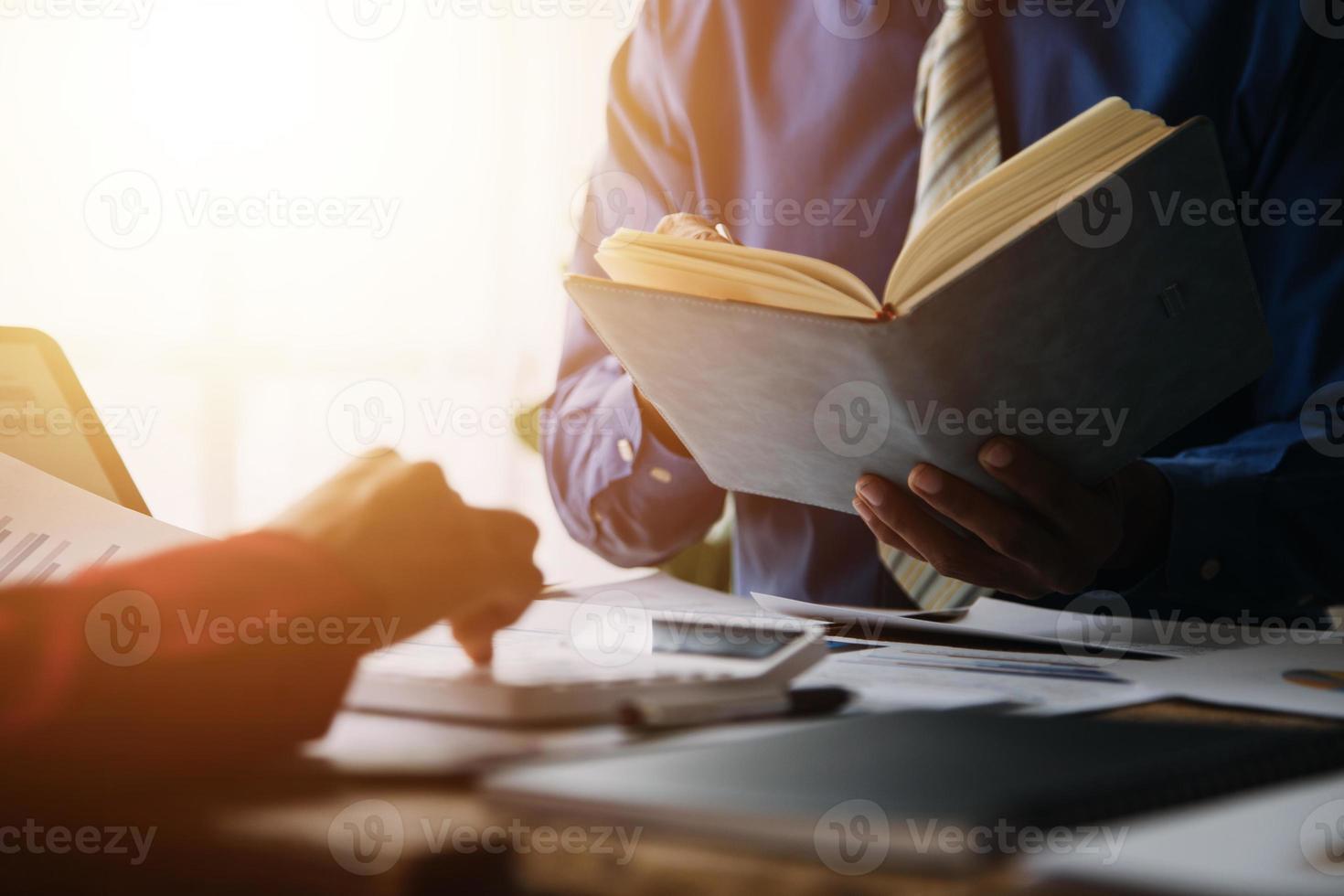 Group of confident business people point to graphs and charts to analyze market data, balance sheet, account, net profit to plan new sales strategies to increase production capacity. photo