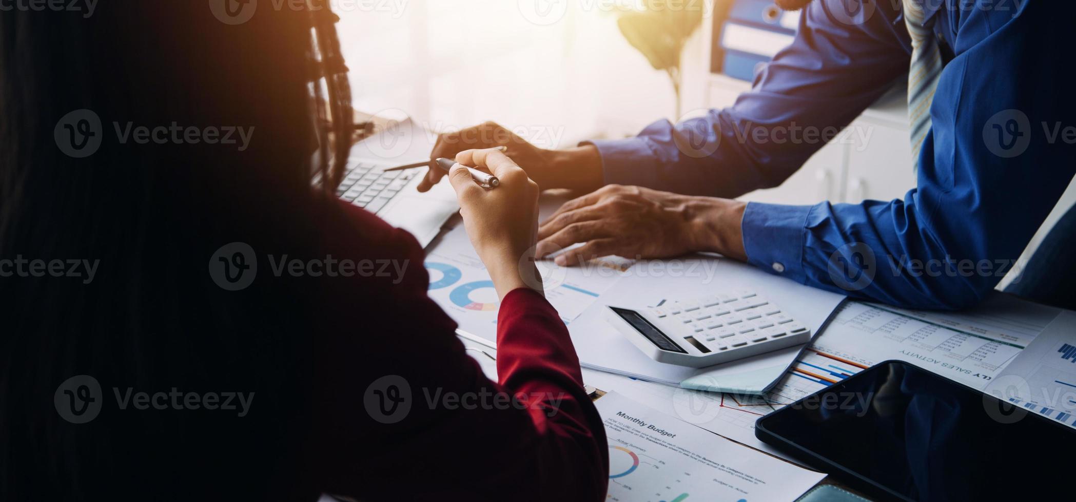 Group of confident business people point to graphs and charts to analyze market data, balance sheet, account, net profit to plan new sales strategies to increase production capacity. photo