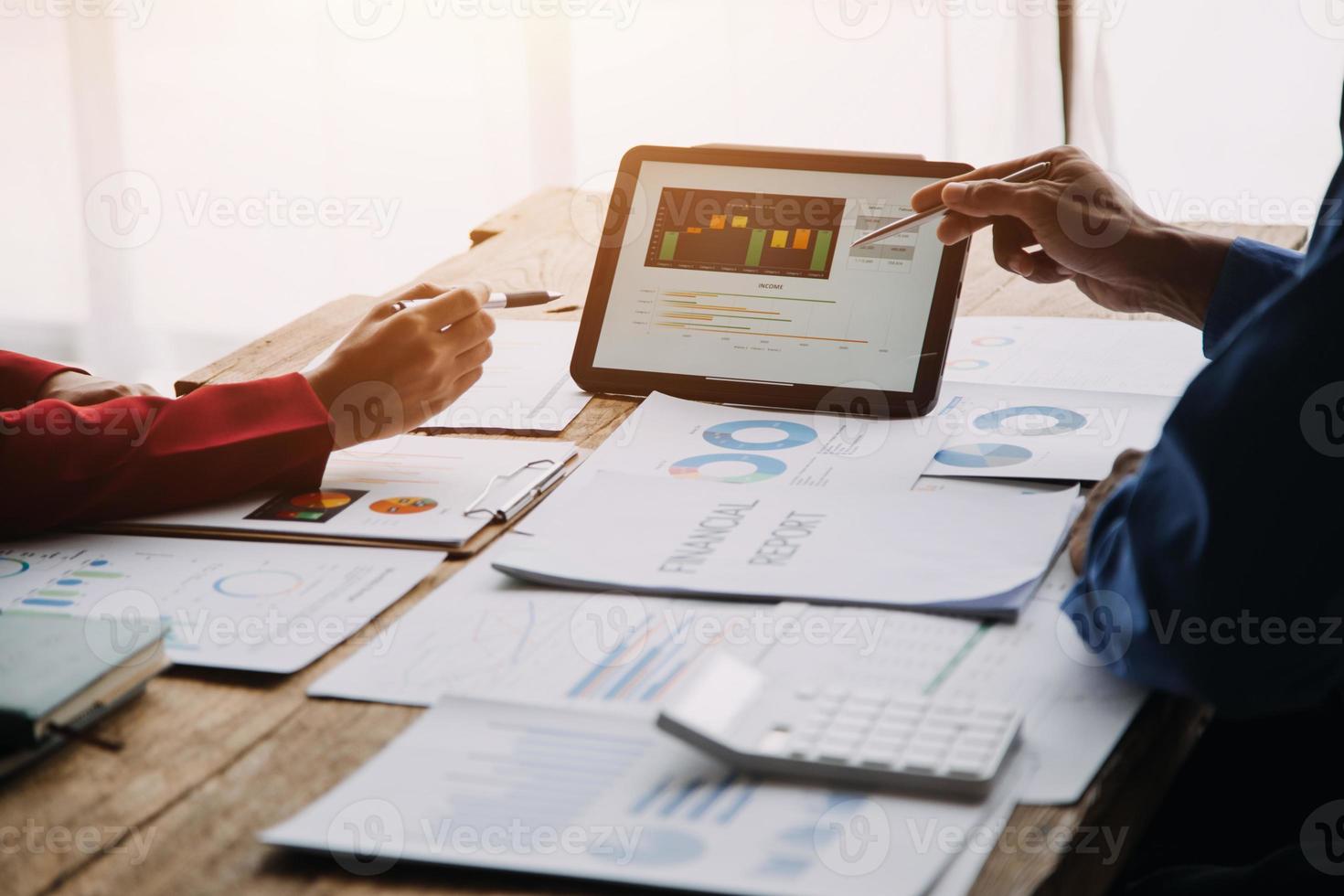 Group of confident business people point to graphs and charts to analyze market data, balance sheet, account, net profit to plan new sales strategies to increase production capacity. photo