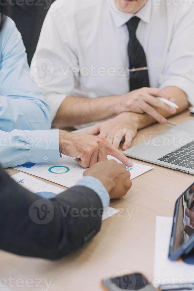 Financial analysts analyze business financial reports on a digital tablet planning investment project during a discussion at a meeting of corporate showing the results of their successful teamwork. photo
