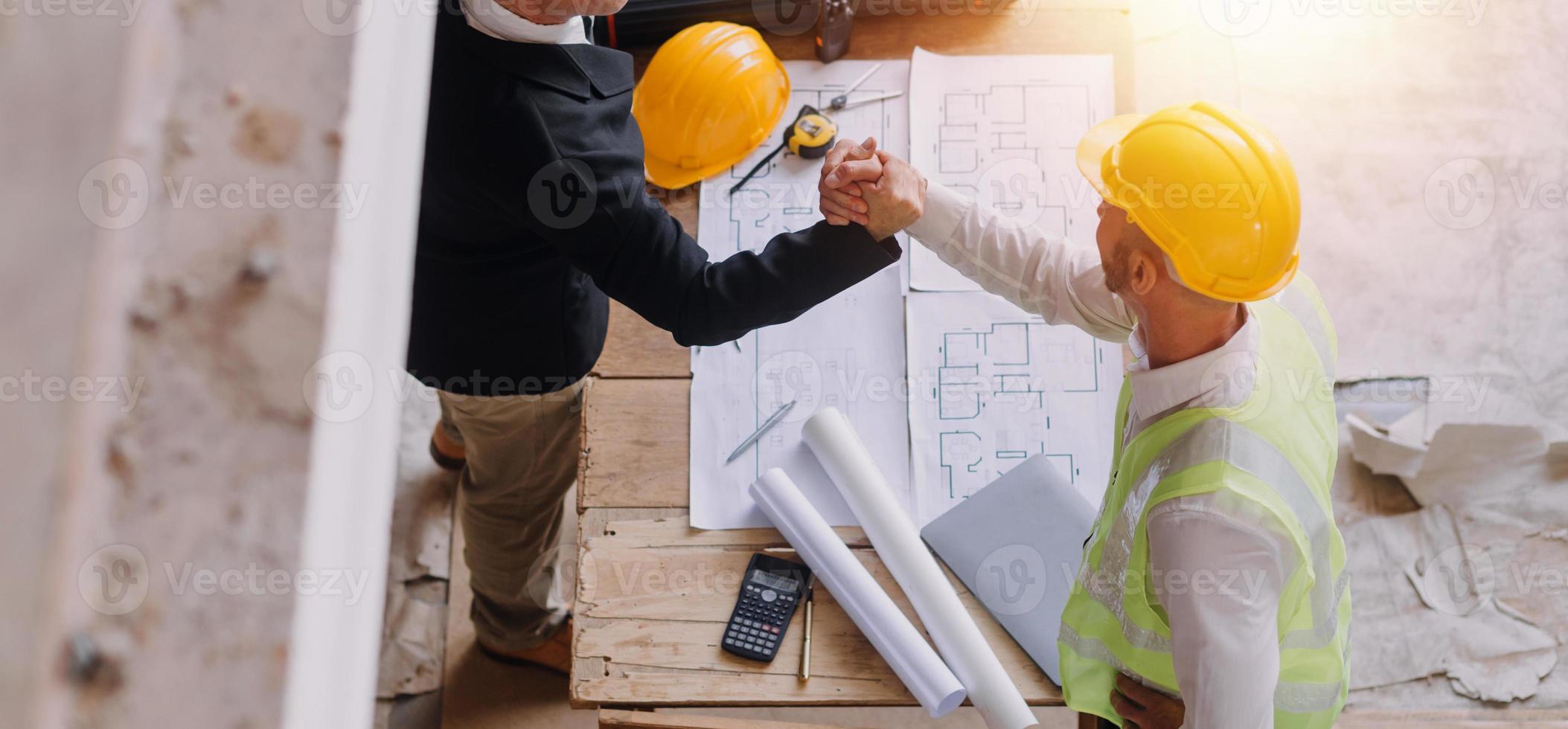 Two business man construction site engineer. Engineering objects on workplace with partners interacting on background photo