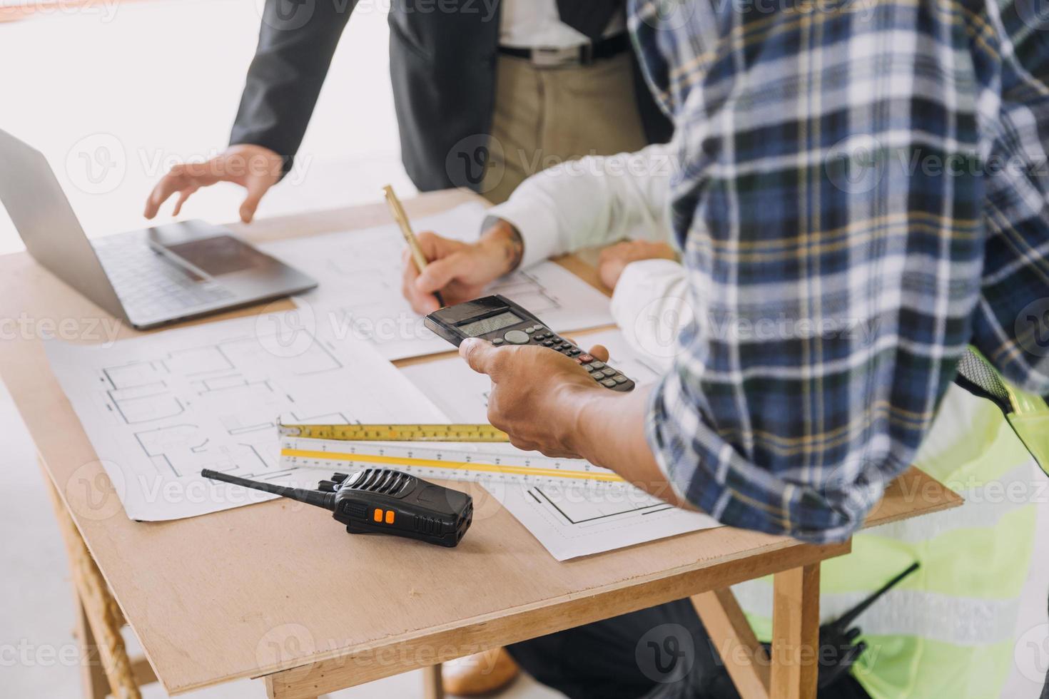 Two business man construction site engineer. Engineering objects on workplace with partners interacting on background photo