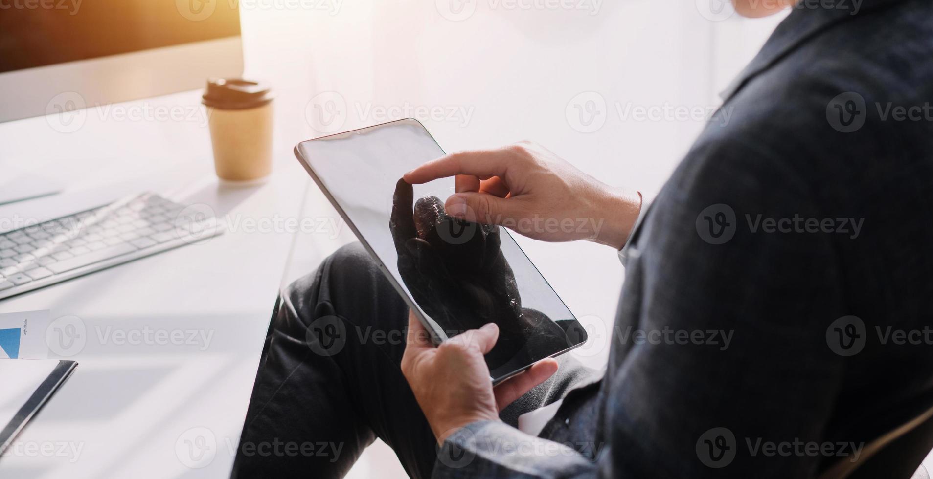 Financial analysts analyze business financial reports on a digital tablet planning investment project during a discussion at a meeting of corporate showing the results of their successful teamwork. photo