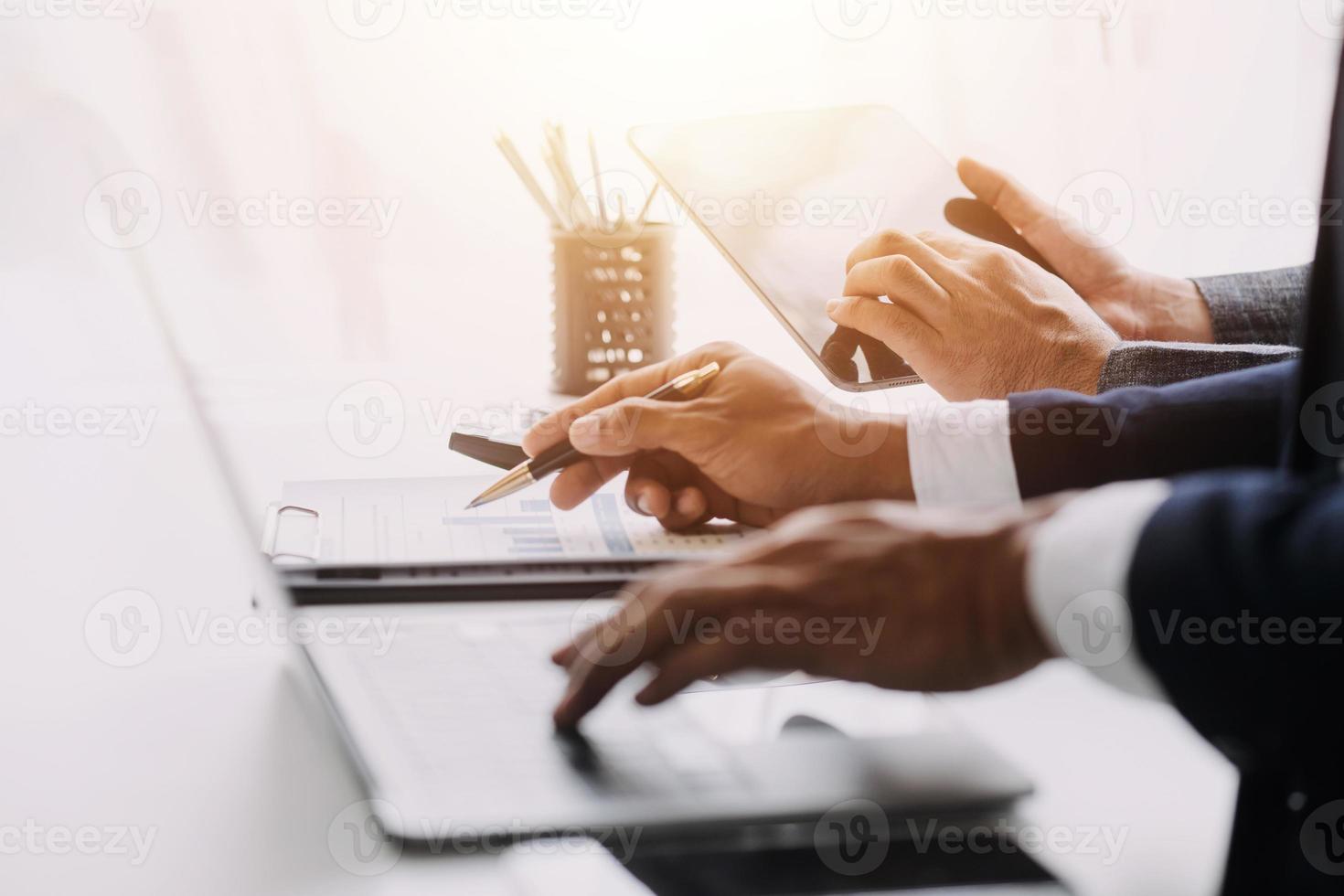 Financial analysts analyze business financial reports on a digital tablet planning investment project during a discussion at a meeting of corporate showing the results of their successful teamwork. photo