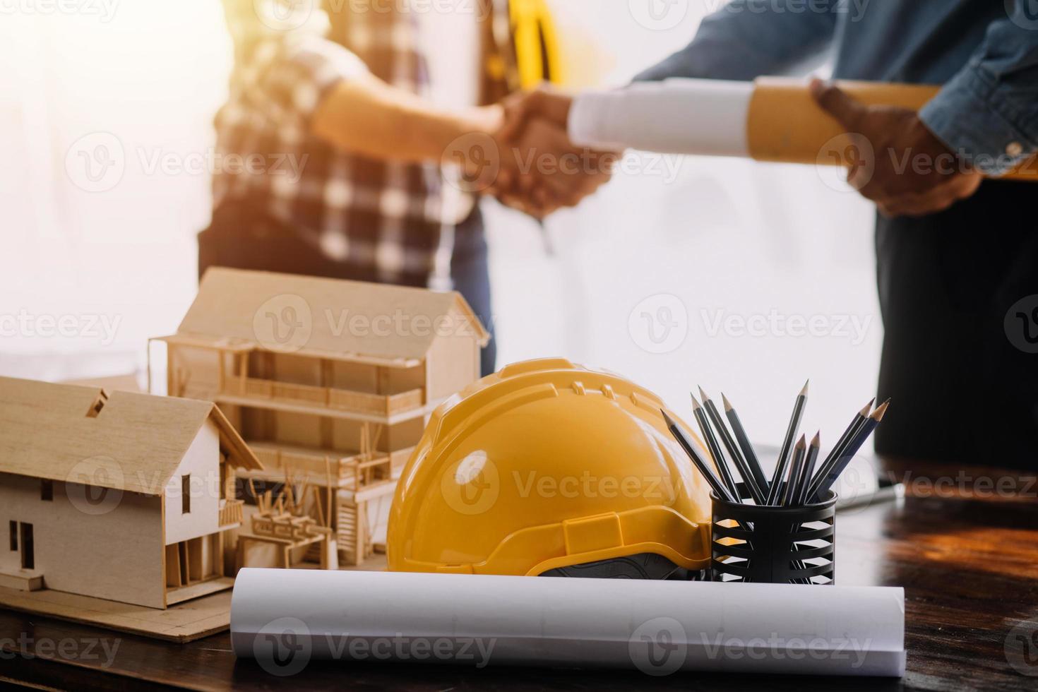 Construction and structure concept of Engineer or architect meeting for project working with partner and engineering tools on model building and blueprint in working site, contract for both companies. photo