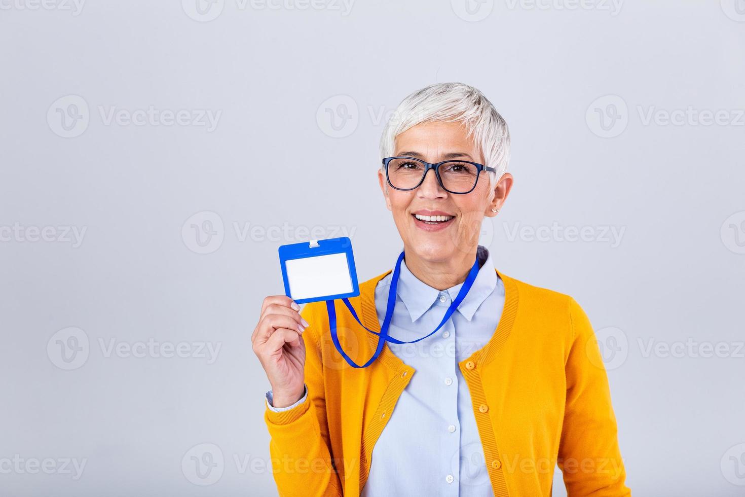 Woman wear blank vertical ID badge mockup, stand isolated. Name tag on neck and chest. Person identity label. Women in shirt uniform with empty id card mock up. Bussinesswoman lanyard design. photo