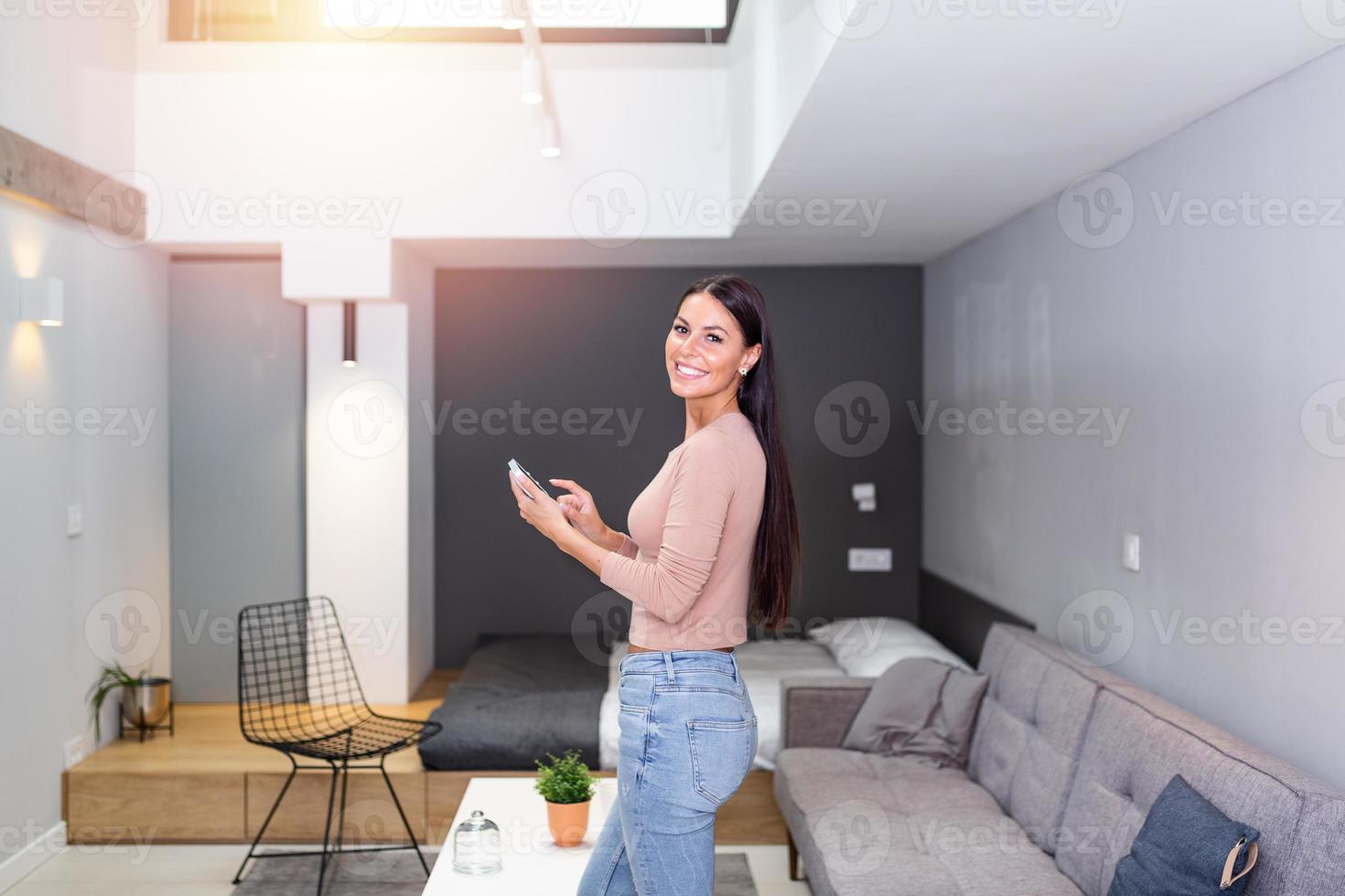 Smart home technology interface on smart controler app screen with augmented reality view of internet of things connected objects in the apartment interior, person holding device photo