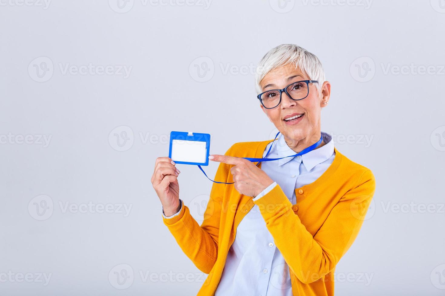 Woman wear blank vertical ID badge mockup, stand isolated. Name tag on neck and chest. Person identity label. Women in shirt uniform with empty id card mock up. Bussinesswoman lanyard design. photo