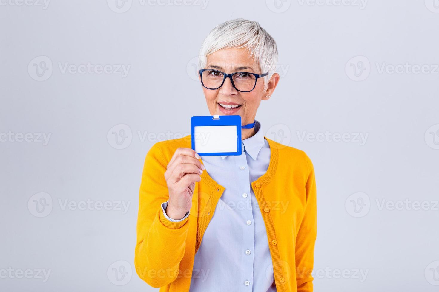 Woman wear blank vertical ID badge mockup, stand isolated. Name tag on neck and chest. Person identity label. Women in shirt uniform with empty id card mock up. Bussinesswoman lanyard design. photo