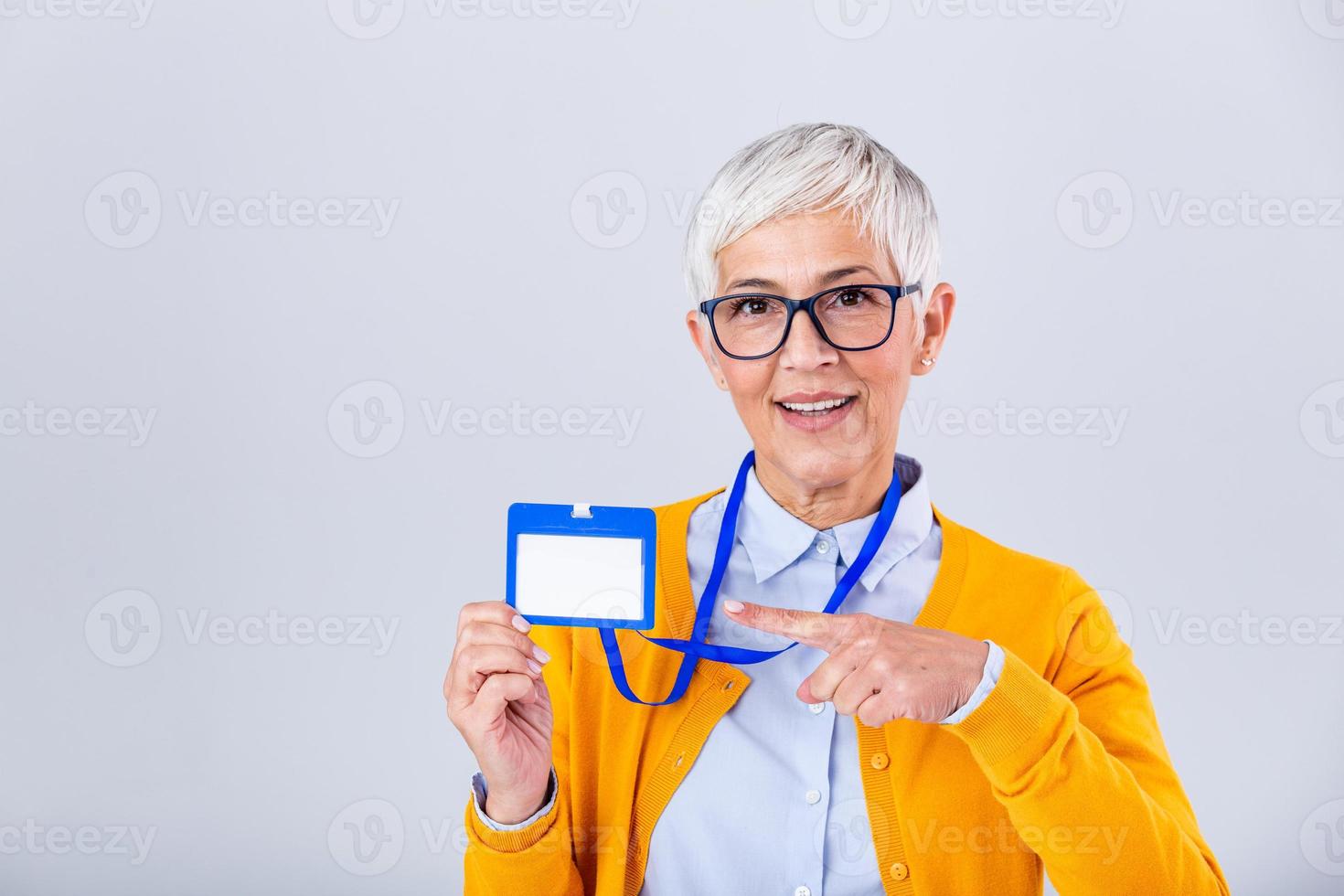 Woman wear blank vertical ID badge mockup, stand isolated. Name tag on neck and chest. Person identity label. Women in shirt uniform with empty id card mock up. Bussinesswoman lanyard design. photo