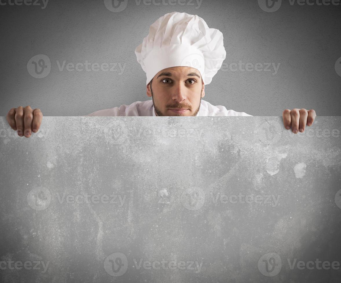 Chef holding a billboard photo