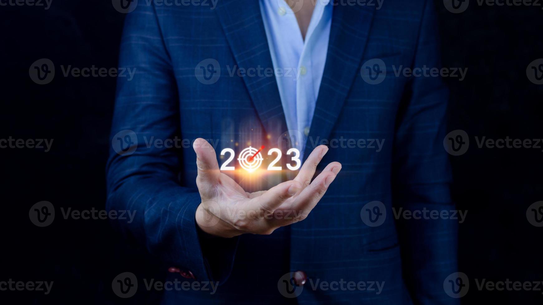 Business target and goal 2023 icon, hand pointing holding 2023 virtual screen, Start new year 2023 with a goal plan, action plan, strategy, new year business vision. photo