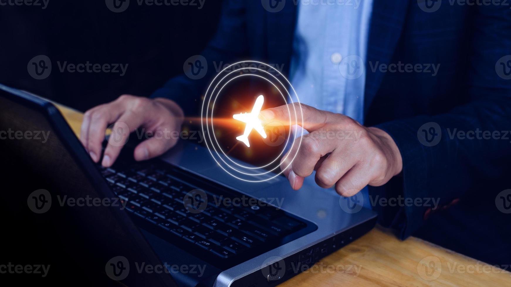 Businessman pointing finger to select flight by pressing touch screen airplane button,Business Airplane transportation concept photo