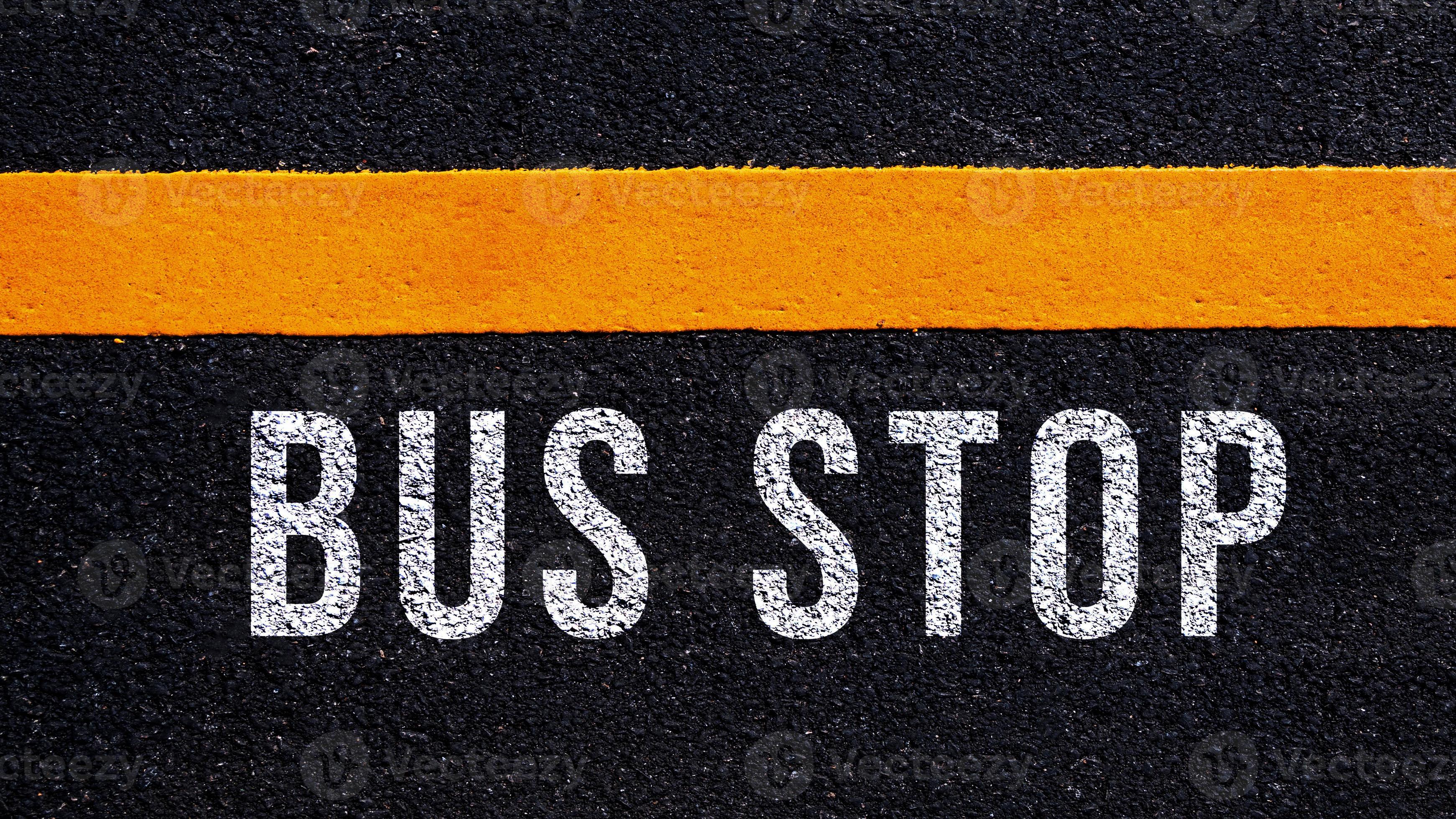 Bus stop text written and yellow line on the road in middle of the ...