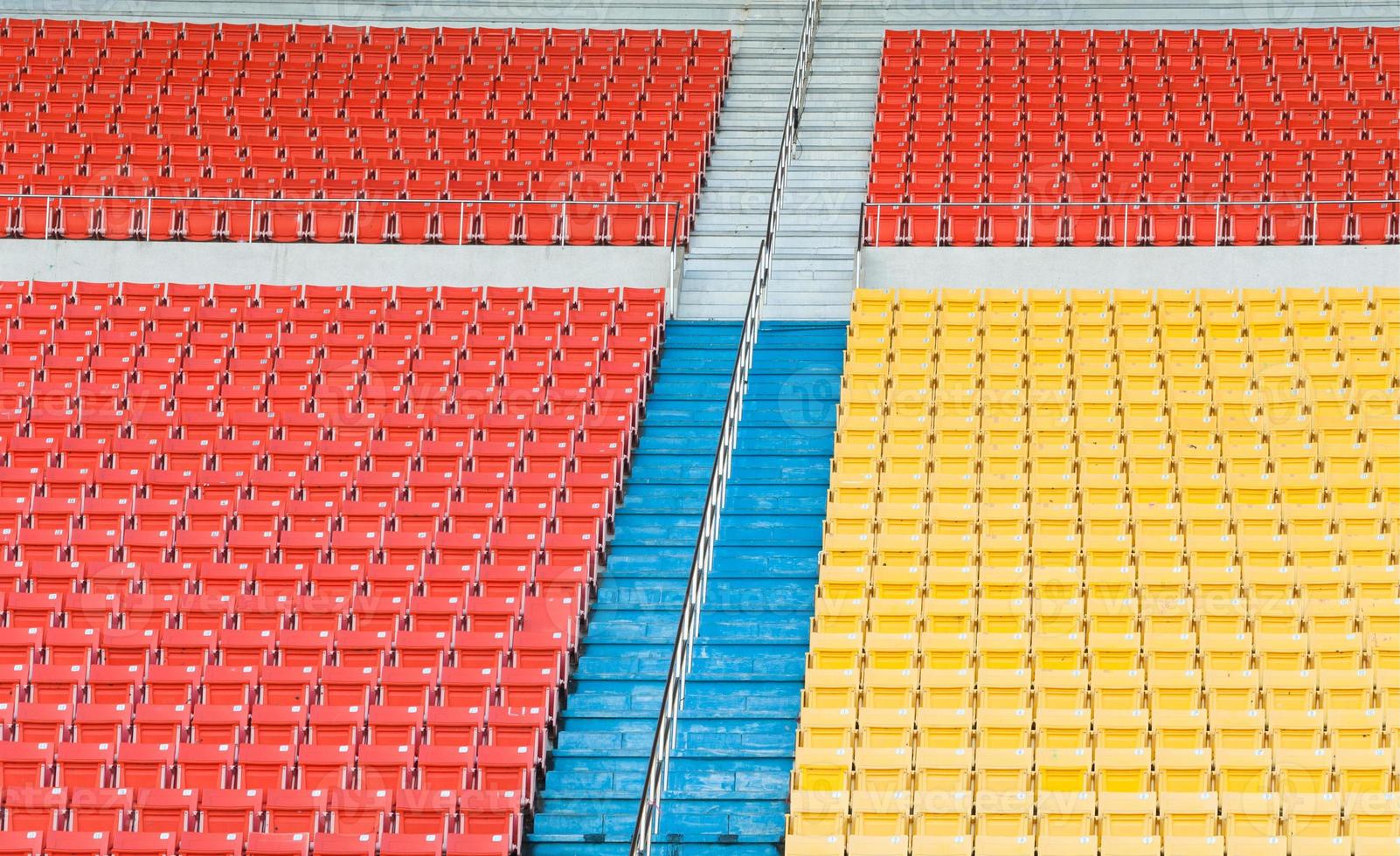 Empty orange and yellow seats at stadium,Rows of seat on a soccer stadium photo