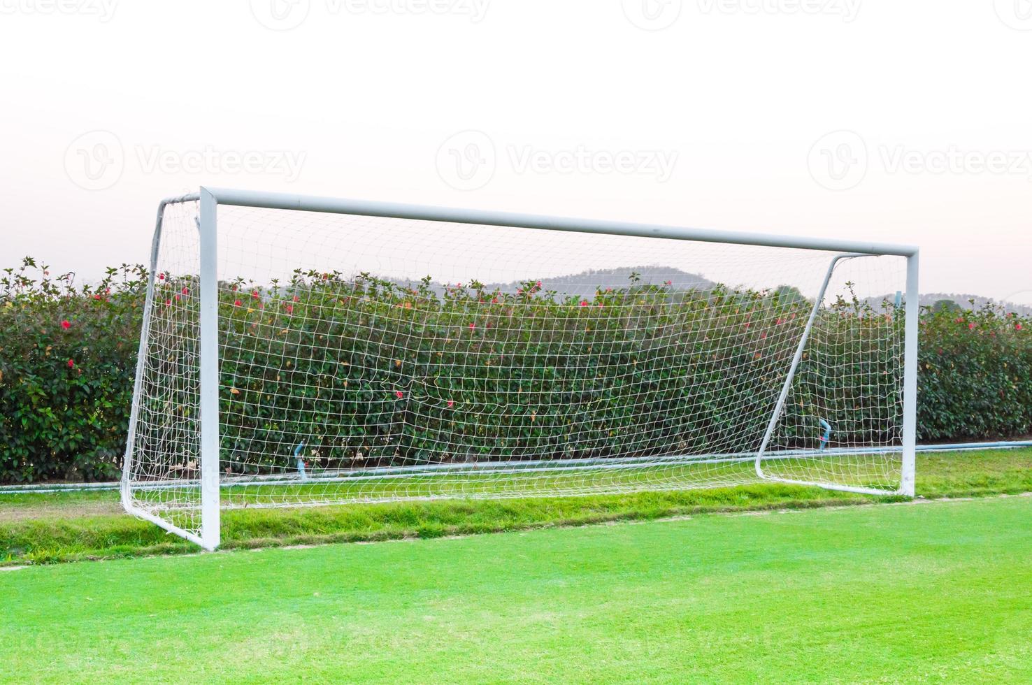 Goal shot from the corner in the front ,soccer field,empty amateur football goal posts and nets photo