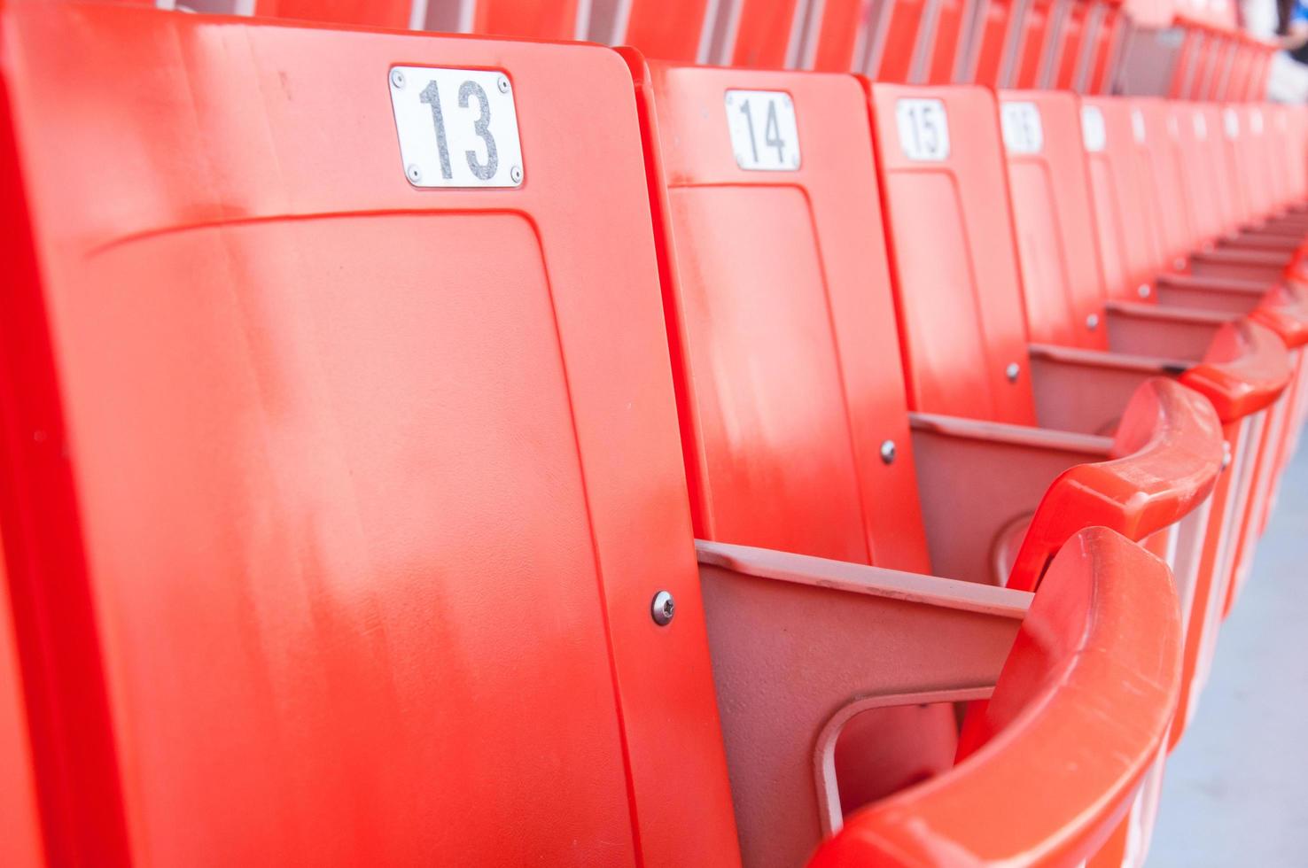 Grandstand seats in stadium, Empty seats in a day without sports,Empty bright red stadium seats photo