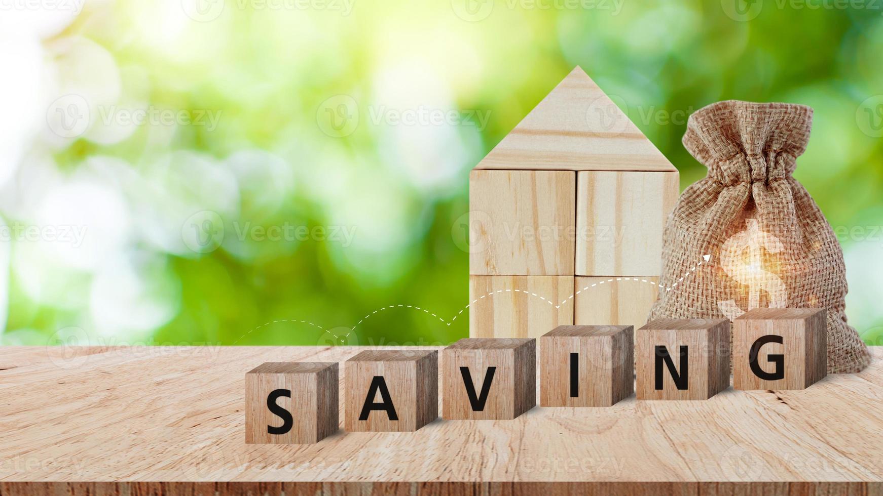 Wooden blocks with words saving and home US dollar money bag for investment loan planned future concept. saving, charity, family finance plan concept, fundraising, superannuation photo