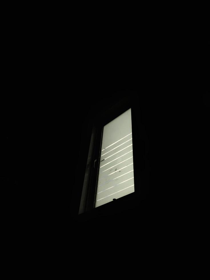 Window in a dark room of an ancient building photo