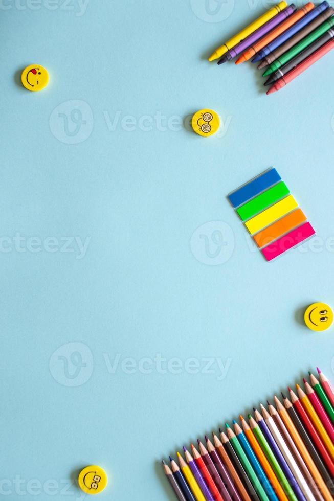 A set of bright stationery items on a blue background. Colour pencils photo