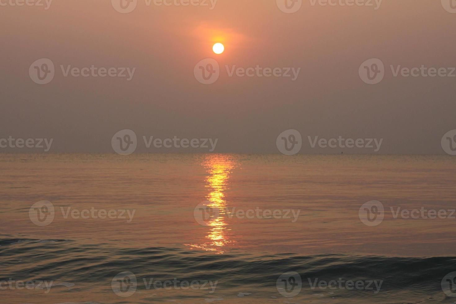 The sun is rising, the sun is bright, the morning sea at Cha-Am Beach photo